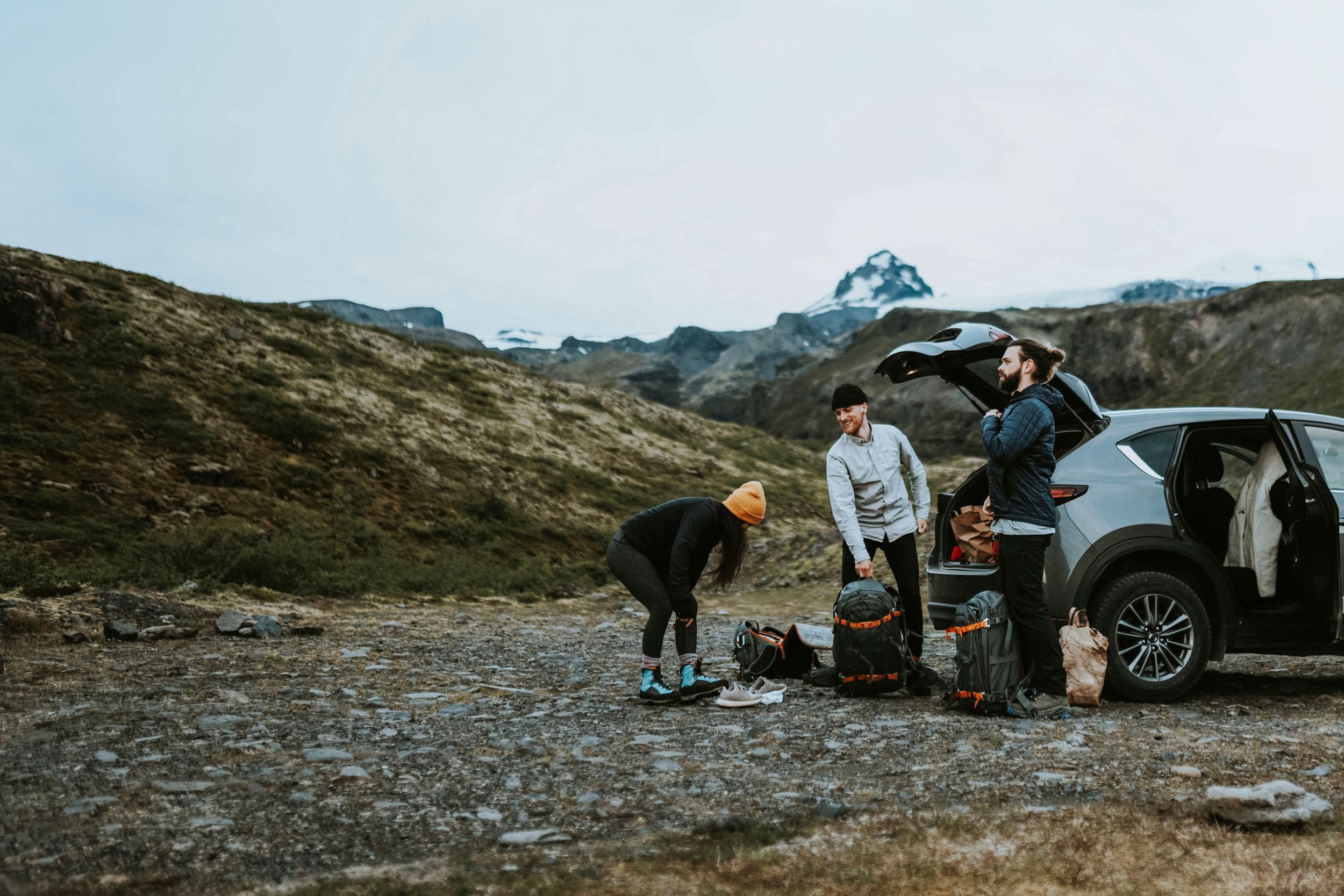 Travelers packing a car for a road trip